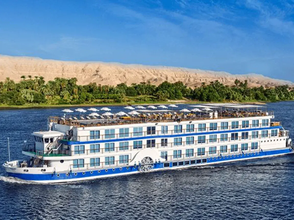 A Nile cruise vessel moored on the river at golden hour