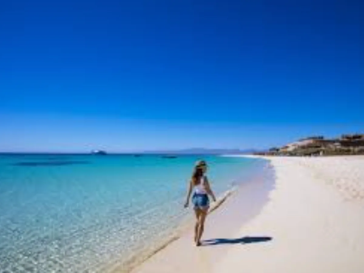 Turquoise Red Sea shallows with a sailing boat anchored offshore