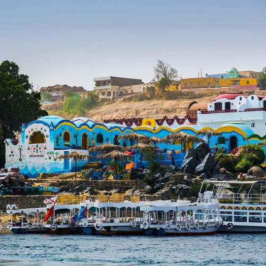 Brightly painted Nubian houses above the Nile at Aswan